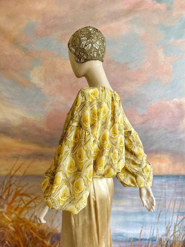 Lemon yellow and sage green silk crepe Calla lily printed blouse with long full sleeves and adjustable drawstring neckline. Bohemian styles sustainably created from antique and vintage textiles by the Pavilion Parade studio. 