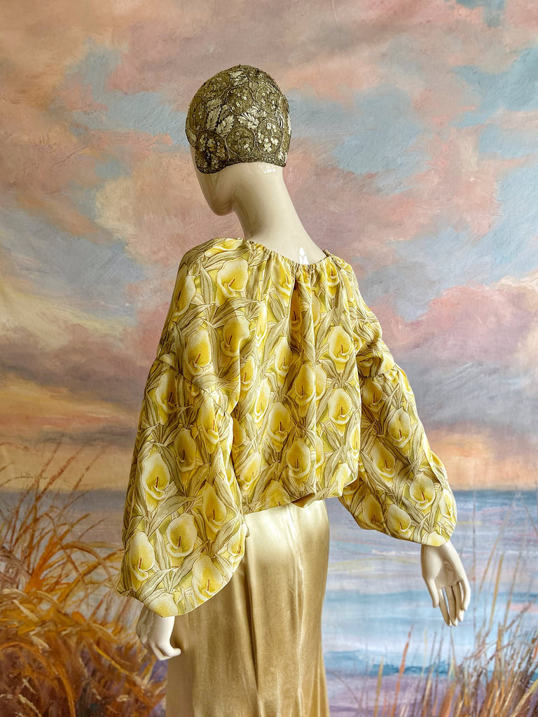 Lemon yellow and sage green silk crepe Calla lily printed blouse with long full sleeves and adjustable drawstring neckline. Bohemian styles sustainably created from antique and vintage textiles by the Pavilion Parade studio. 