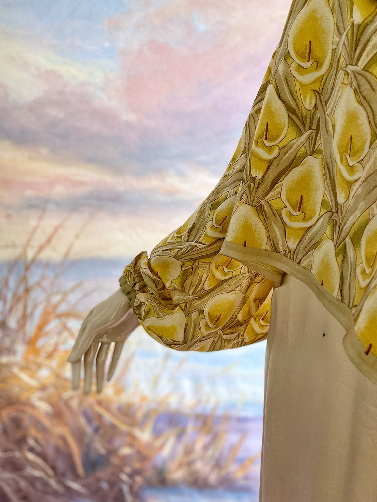 Lemon yellow and sage green silk crepe Calla lily printed blouse with long full sleeves and adjustable drawstring neckline. Bohemian styles sustainably created from antique and vintage textiles by the Pavilion Parade studio. 