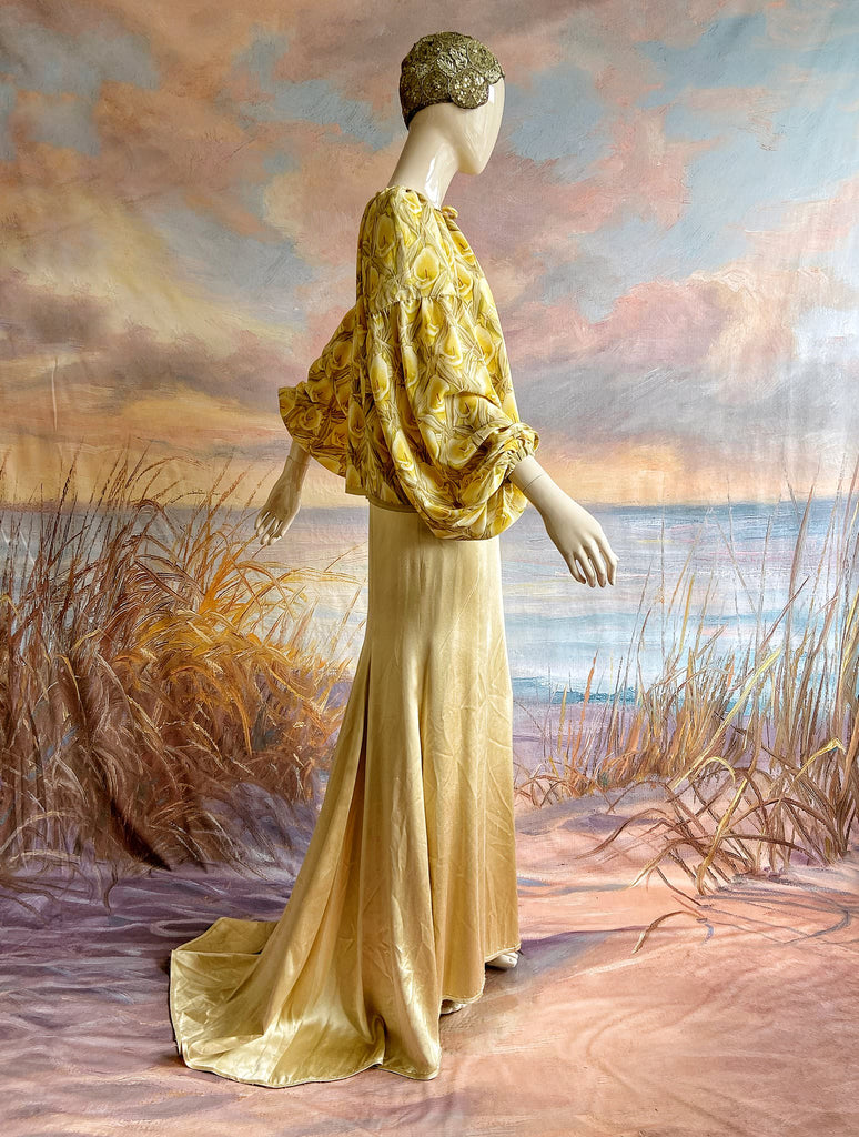 Lemon yellow and sage green silk crepe Calla lily printed blouse with long full sleeves and adjustable drawstring neckline. Bohemian styles sustainably created from antique and vintage textiles by the Pavilion Parade studio. 