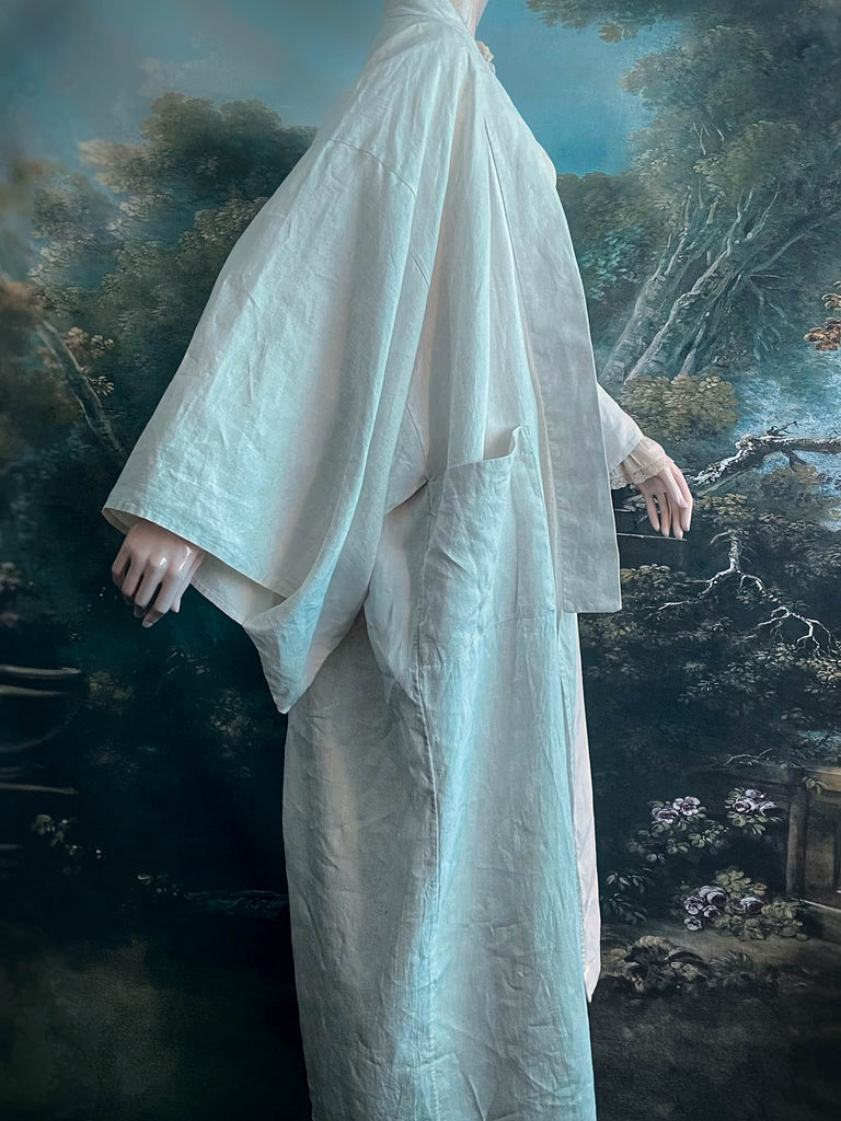 Full length kimono inspired robe with large patch pockets. Newly created from a bolt of deadstock early 20th century antique French flax linen. All French seamed with hand finished hems and collar. Bohemian styles sustainably created from antique and vintage textiles by the Pavilion Parade studio.