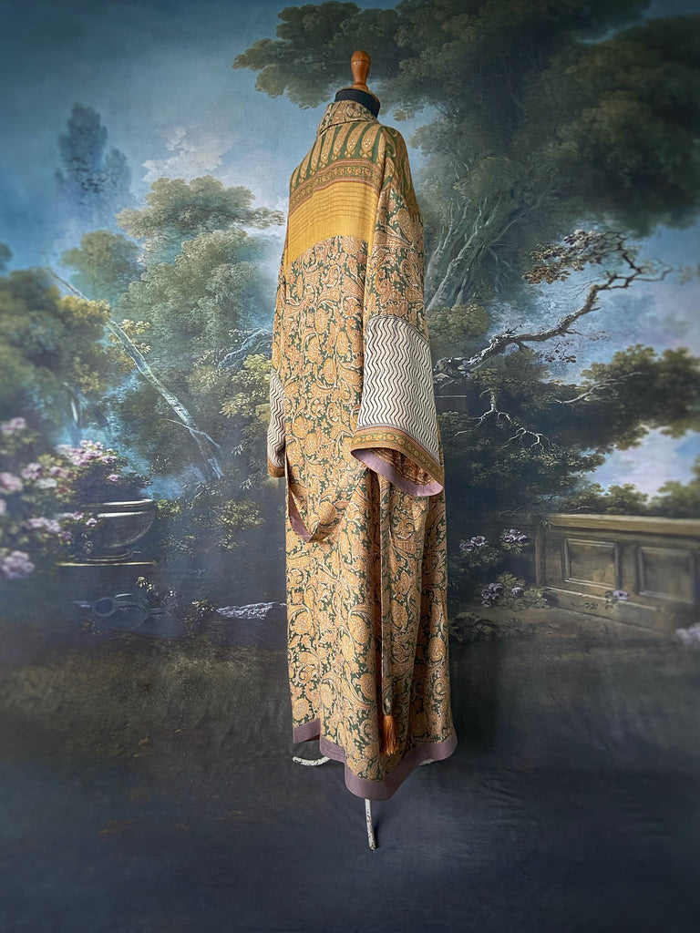 Mustard yellow and moss green paisley block print fine wool dressing robe with wide sleeves, patch pockets and tassel tie sash. Bohemian styles created from antique and vintage textiles by the Pavilion Parade Studio