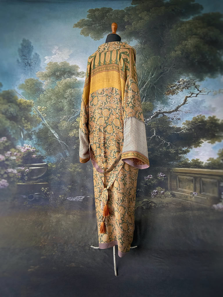 Mustard yellow and moss green paisley block print fine wool dressing robe with wide sleeves, patch pockets and tassel tie sash. Bohemian styles created from antique and vintage textiles by the Pavilion Parade Studio