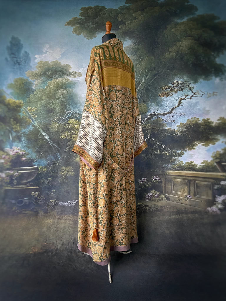 Mustard yellow and moss green paisley block print fine wool dressing robe with wide sleeves, patch pockets and tassel tie sash. Bohemian styles created from antique and vintage textiles by the Pavilion Parade Studio