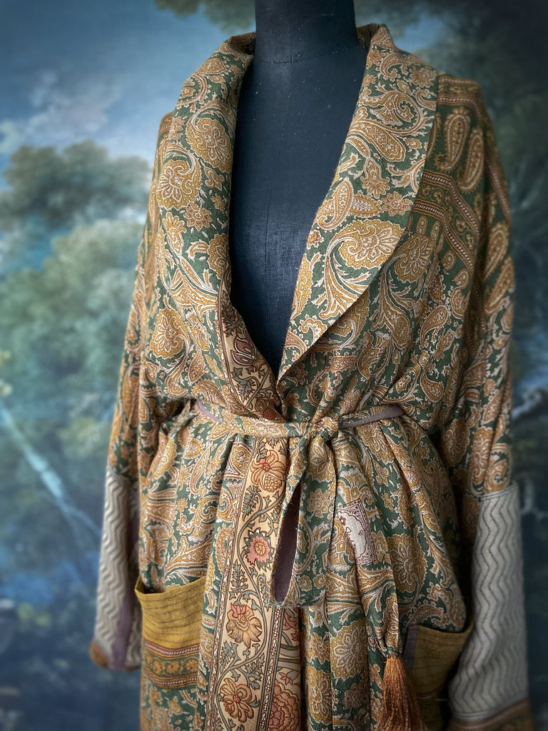 Mustard yellow and moss green paisley block print fine wool dressing robe with wide sleeves, patch pockets and tassel tie sash. Bohemian styles created from antique and vintage textiles by the Pavilion Parade Studio