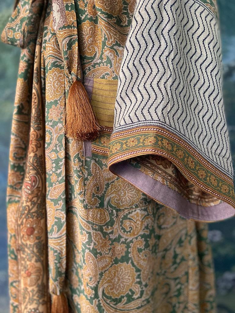 Mustard yellow and moss green paisley block print fine wool dressing robe with wide sleeves, patch pockets and tassel tie sash. Bohemian styles created from antique and vintage textiles by the Pavilion Parade Studio