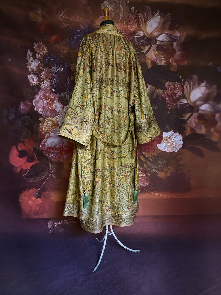 Hand embroidered kantha olive green pure silk robe with wide sleeves, tassel sash and patch pockets. Bohemian style created from vintage and antique textiles by Pavilion Parade