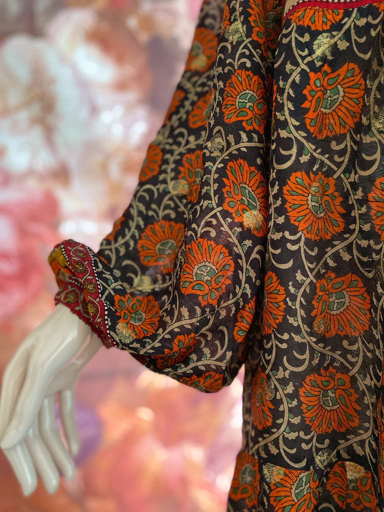 Black, burnt orange, and chilli red silk georgette maxi dress with tassel drawstring neckline, long full sleeves and side pockets. Bohemian style sustainably created from vintage and antique textiles by the Pavilion Parade studio.
