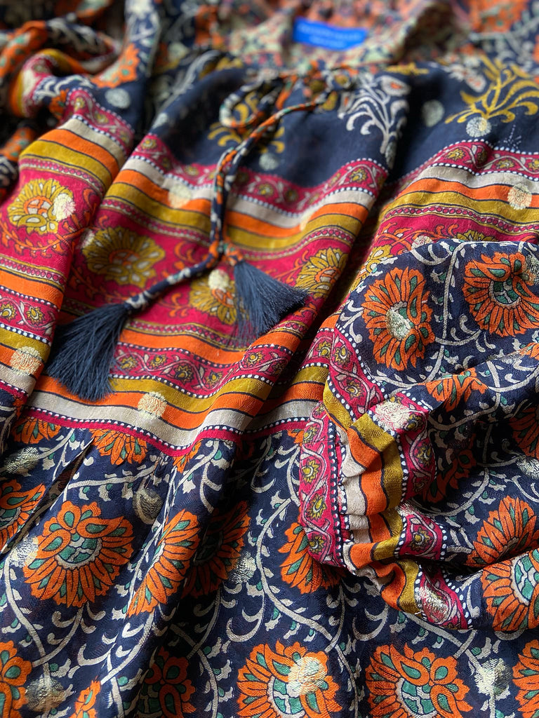 Black, burnt orange, and chilli red silk georgette maxi dress with tassel drawstring neckline, long full sleeves and side pockets. Bohemian style sustainably created from vintage and antique textiles by the Pavilion Parade studio.