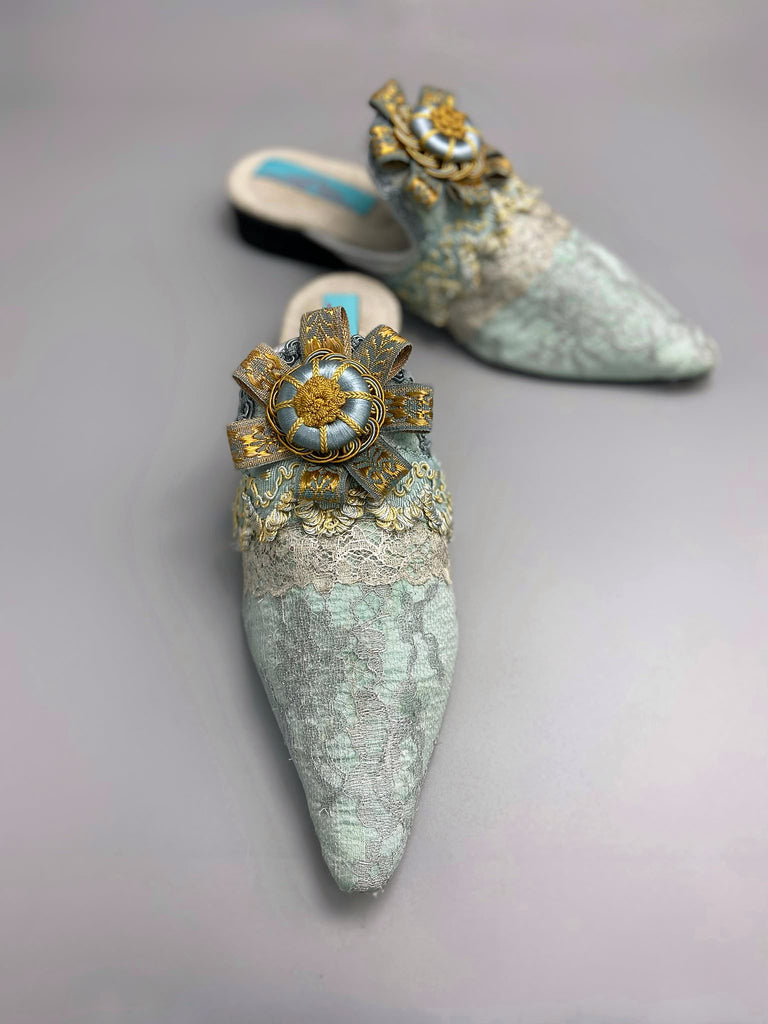 Silver lace and pale blue silk Georgian inspired mules with ribbon rosettes. Bohemian styles sustainably created from antique textiles by the Pavilion Parade studio.