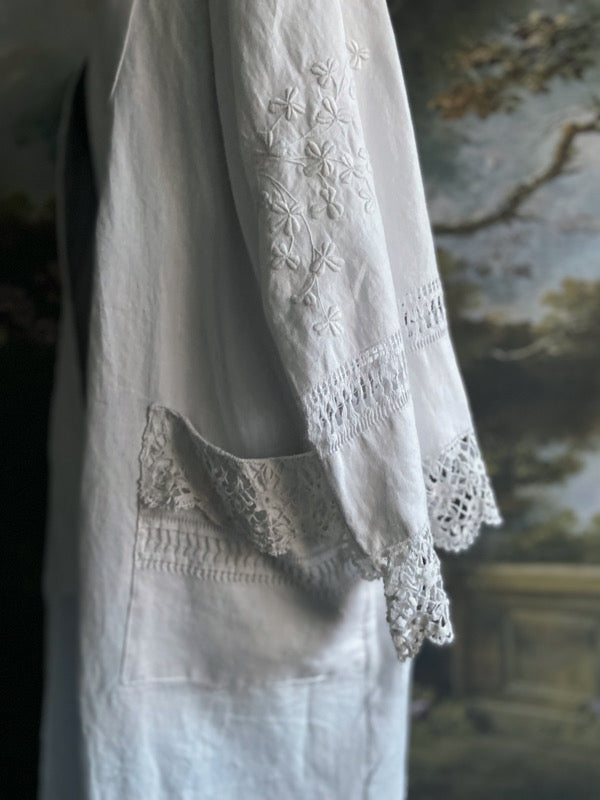Full length kimono inspired robe with large patch pockets and wide sleeves. Created from an antique Irish linen monogrammed sheet with hand embroidered clover leaves, lace and drawn thread work. All French seamed with hand finished hems and collar. Bohemian styles sustainably created from antique and vintage textiles by the Pavilion Parade studio.