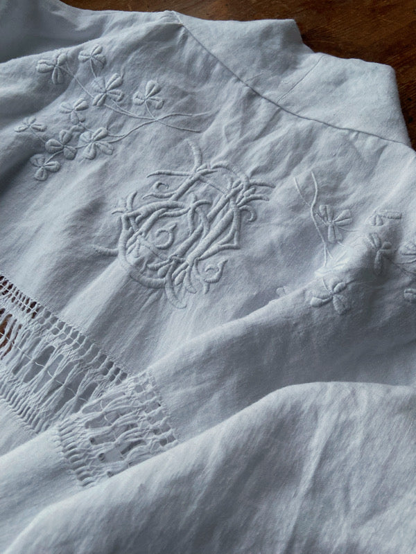 Full length kimono inspired robe with large patch pockets and wide sleeves. Created from an antique Irish linen monogrammed sheet with hand embroidered clover leaves, lace and drawn thread work. All French seamed with hand finished hems and collar. Bohemian styles sustainably created from antique and vintage textiles by the Pavilion Parade studio.