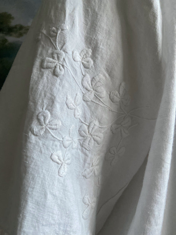 Full length kimono inspired robe with large patch pockets and wide sleeves. Created from an antique Irish linen monogrammed sheet with hand embroidered clover leaves, lace and drawn thread work. All French seamed with hand finished hems and collar. Bohemian styles sustainably created from antique and vintage textiles by the Pavilion Parade studio.