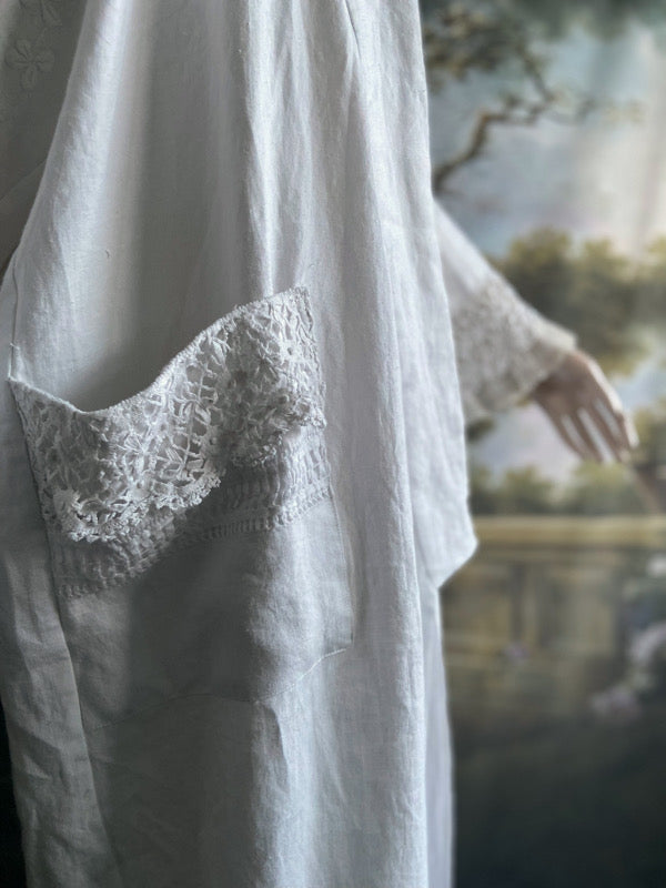 Full length kimono inspired robe with large patch pockets and wide sleeves. Created from an antique Irish linen monogrammed sheet with hand embroidered clover leaves, lace and drawn thread work. All French seamed with hand finished hems and collar. Bohemian styles sustainably created from antique and vintage textiles by the Pavilion Parade studio.