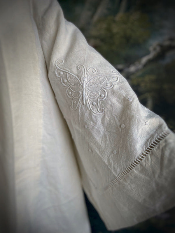 Full length kimono inspired robe with large patch pockets and wide sleeves. Created from an antique heavy French linen monogrammed trousseau sheet with hand embroidered butterflies and drawn thread work. All French seamed with hand finished hems and collar. Bohemian styles sustainably created from antique and vintage textiles by the Pavilion Parade studio.