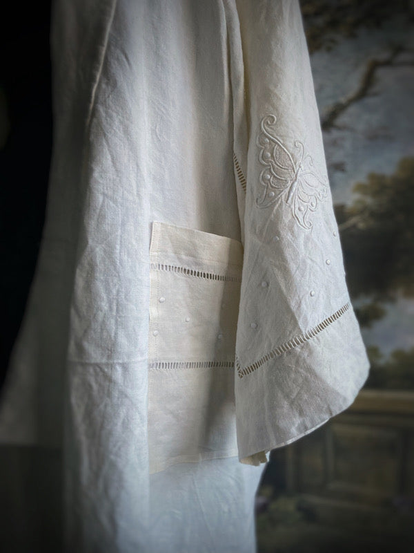 Full length kimono inspired robe with large patch pockets and wide sleeves. Created from an antique heavy French linen monogrammed trousseau sheet with hand embroidered butterflies and drawn thread work. All French seamed with hand finished hems and collar. Bohemian styles sustainably created from antique and vintage textiles by the Pavilion Parade studio.