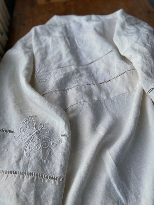 Full length kimono inspired robe with large patch pockets and wide sleeves. Created from an antique heavy French linen monogrammed trousseau sheet with hand embroidered butterflies and drawn thread work. All French seamed with hand finished hems and collar. Bohemian styles sustainably created from antique and vintage textiles by the Pavilion Parade studio.