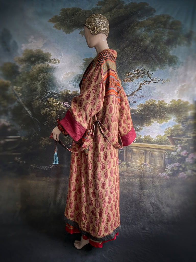 Burgundy red, sand and pumpkin orange fine wool robe with peacock motif silk lining. Wide sleeves, deep pockets and tassel sash. Unique bohemian style created from vintage and antique textiles by the Pavilion Parade studio.