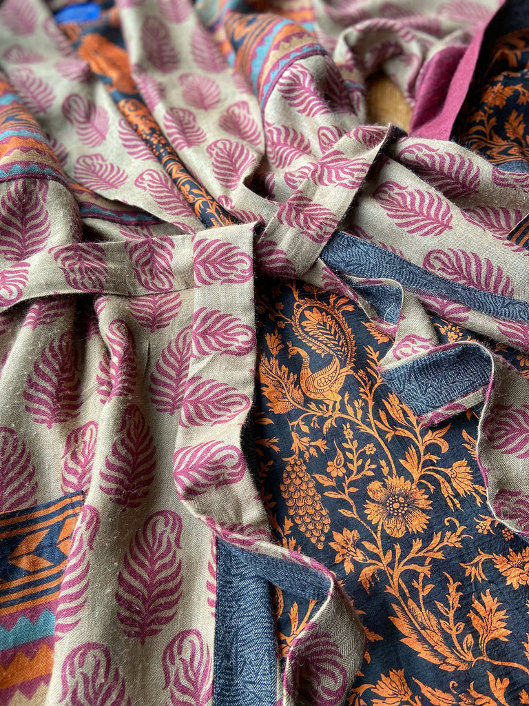 Burgundy red, sand and pumpkin orange fine wool robe with peacock motif silk lining. Wide sleeves, deep pockets and tassel sash. Unique bohemian style created from vintage and antique textiles by the Pavilion Parade studio.