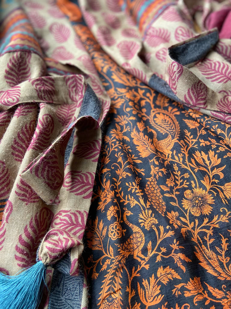 Burgundy red, sand and pumpkin orange fine wool robe with peacock motif silk lining. Wide sleeves, deep pockets and tassel sash. Unique bohemian style created from vintage and antique textiles by the Pavilion Parade studio.