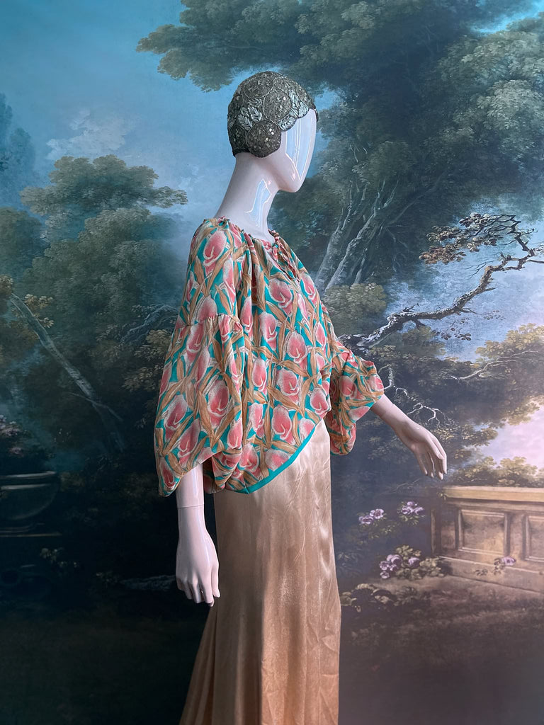 Rose pink and turquoise silk georgette Calla lily printed blouse with long full sleeves and adjustable drawstring neckline. Bohemian styles sustainably created from antique and vintage textiles by the Pavilion Parade studio. 