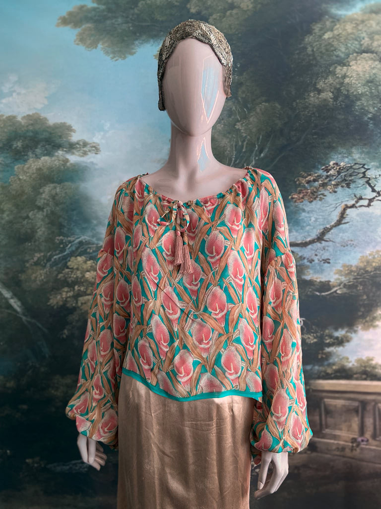 Rose pink and turquoise silk georgette Calla lily printed blouse with long full sleeves and adjustable drawstring neckline. Bohemian styles sustainably created from antique and vintage textiles by the Pavilion Parade studio. 