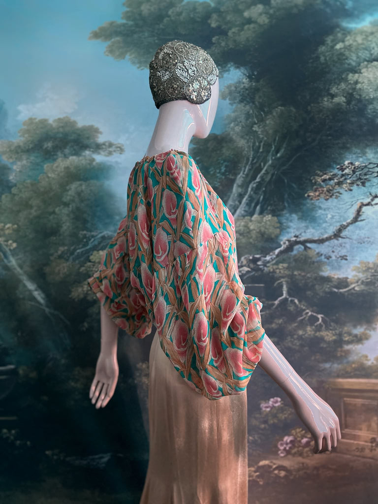 Rose pink and turquoise silk georgette Calla lily printed blouse with long full sleeves and adjustable drawstring neckline. Bohemian styles sustainably created from antique and vintage textiles by the Pavilion Parade studio. 