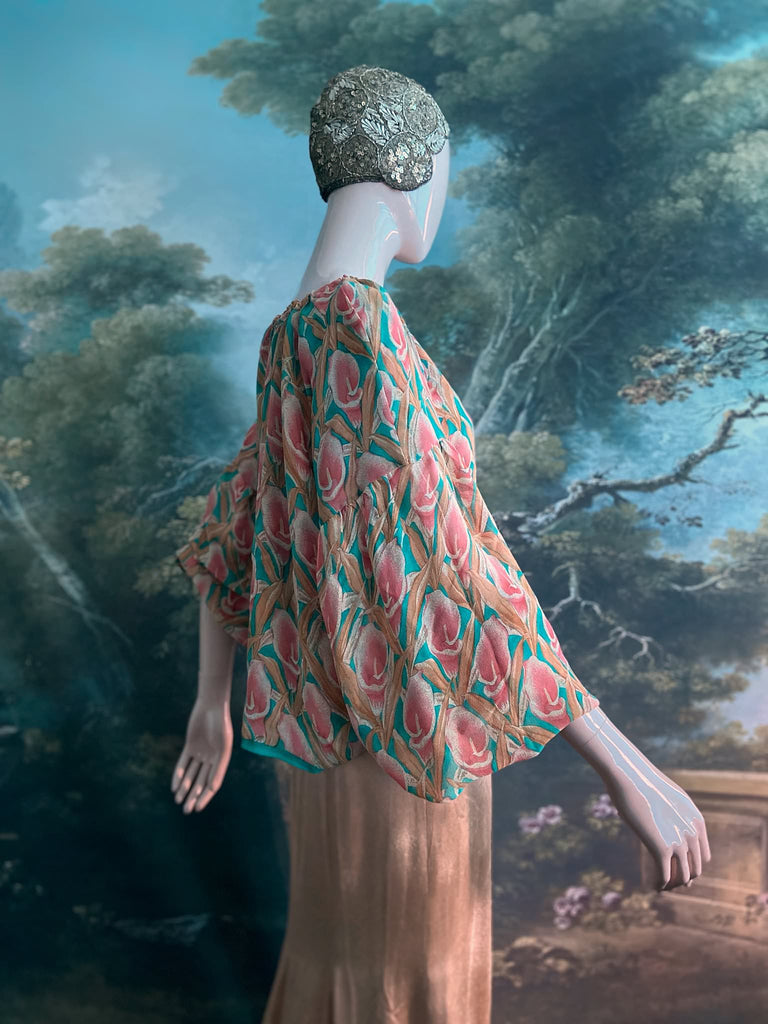 Rose pink and turquoise silk georgette Calla lily printed blouse with long full sleeves and adjustable drawstring neckline. Bohemian styles sustainably created from antique and vintage textiles by the Pavilion Parade studio. 