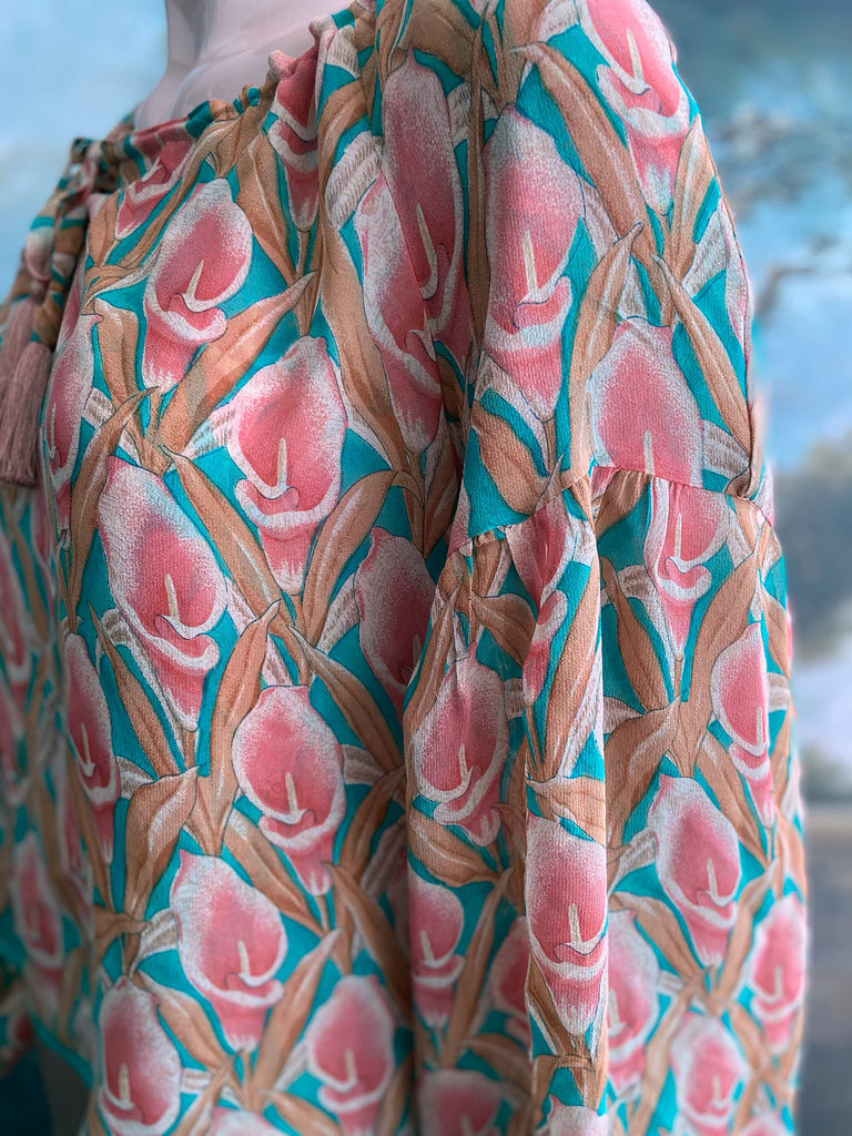 Rose pink and turquoise silk georgette Calla lily printed blouse with long full sleeves and adjustable drawstring neckline. Bohemian styles sustainably created from antique and vintage textiles by the Pavilion Parade studio. 