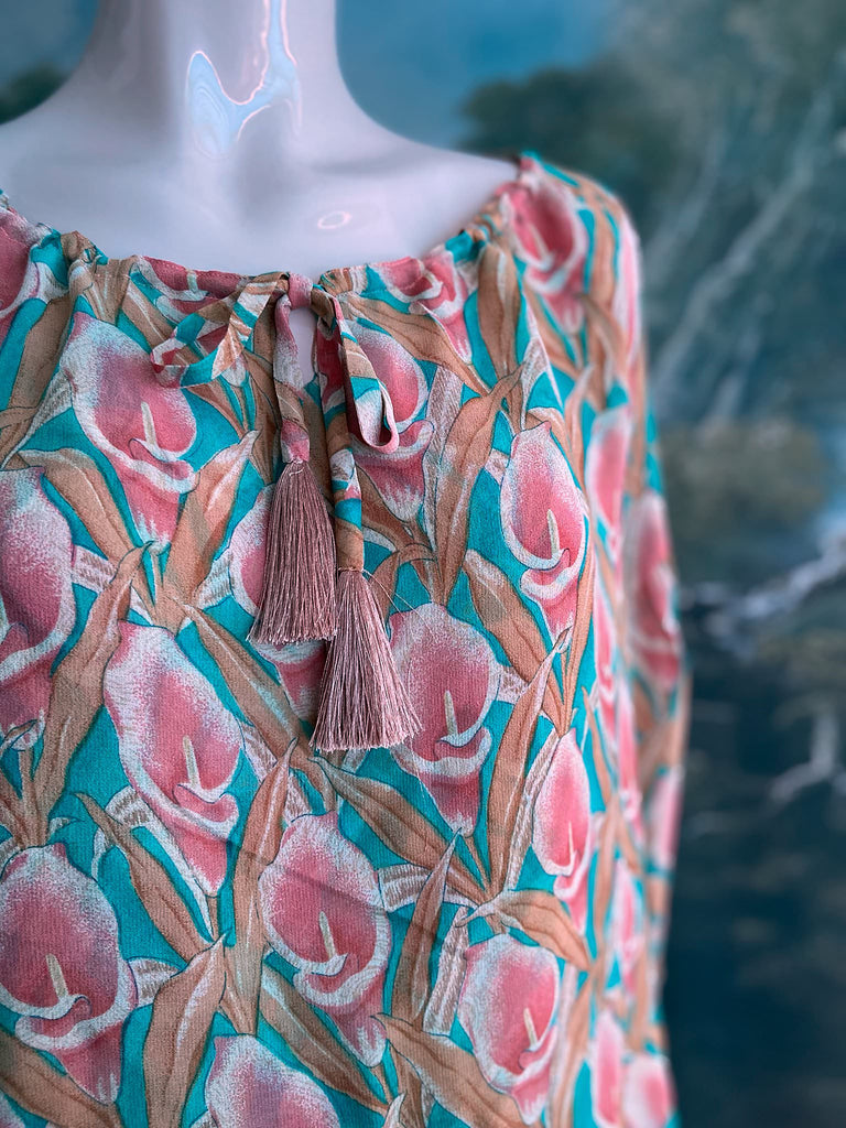 Rose pink and turquoise silk georgette Calla lily printed blouse with long full sleeves and adjustable drawstring neckline. Bohemian styles sustainably created from antique and vintage textiles by the Pavilion Parade studio. 