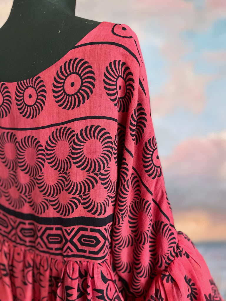 Vibrant pink and black block printed fine cotton muslin volume dress.  Balloon sleeves, ankle length, with pockets. Unique bohemian garments sustainably created from antique and vintage textiles by the Pavilion Parade studio.