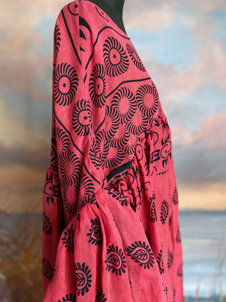 Vibrant pink and black block printed fine cotton muslin volume dress.  Balloon sleeves, ankle length, with pockets. Unique bohemian garments sustainably created from antique and vintage textiles by the Pavilion Parade studio.