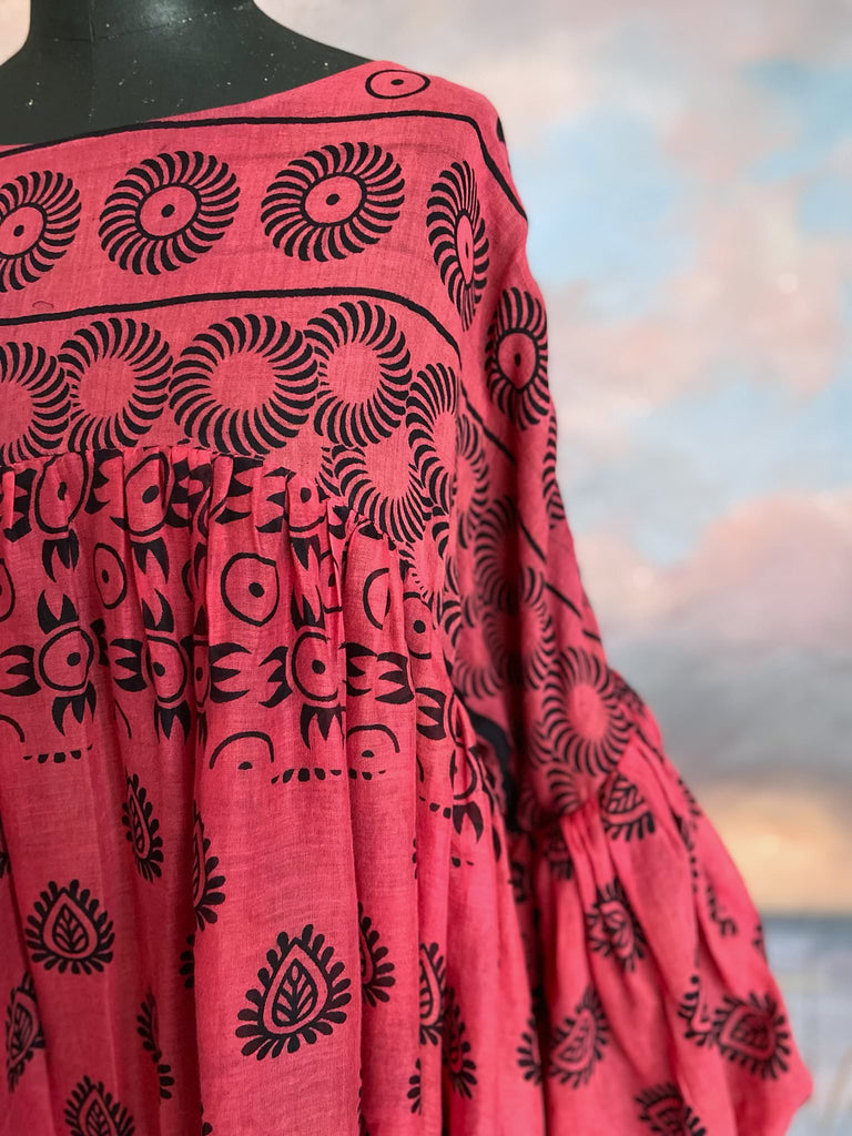 Vibrant pink and black block printed fine cotton muslin volume dress.  Balloon sleeves, ankle length, with pockets. Unique bohemian garments sustainably created from antique and vintage textiles by the Pavilion Parade studio.