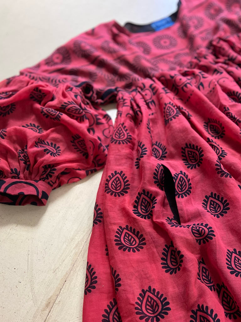 Vibrant pink and black block printed fine cotton muslin volume dress.  Balloon sleeves, ankle length, with pockets. Unique bohemian garments sustainably created from antique and vintage textiles by the Pavilion Parade studio.