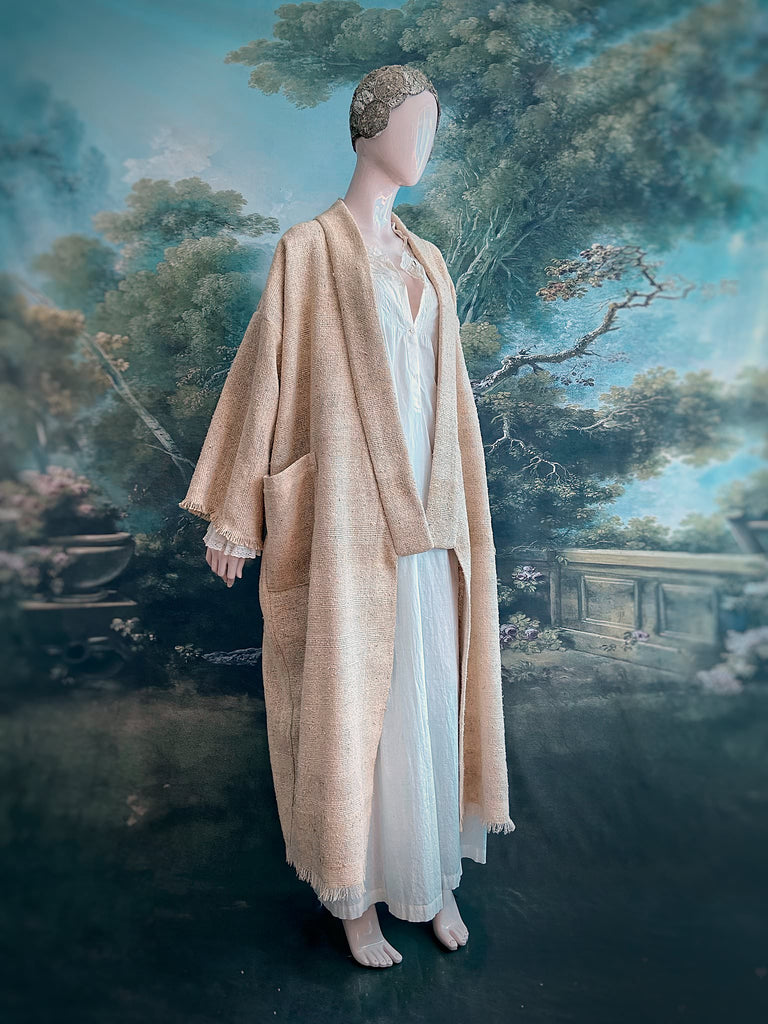 Full length kimono inspired robe with large patch pockets. Newly created from a bolt end of vintage raw silk with the colour and texture of antique hemp grain sacks. All French seamed with hand finished hems and collar. Bohemian styles sustainably created from antique and vintage textiles by the Pavilion Parade studio.