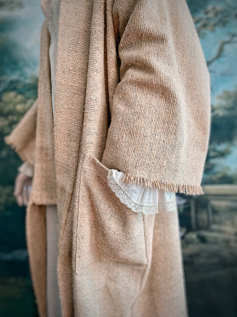 Full length kimono inspired robe with large patch pockets. Newly created from a bolt end of vintage raw silk with the colour and texture of antique hemp grain sacks. All French seamed with hand finished hems and collar. Bohemian styles sustainably created from antique and vintage textiles by the Pavilion Parade studio.