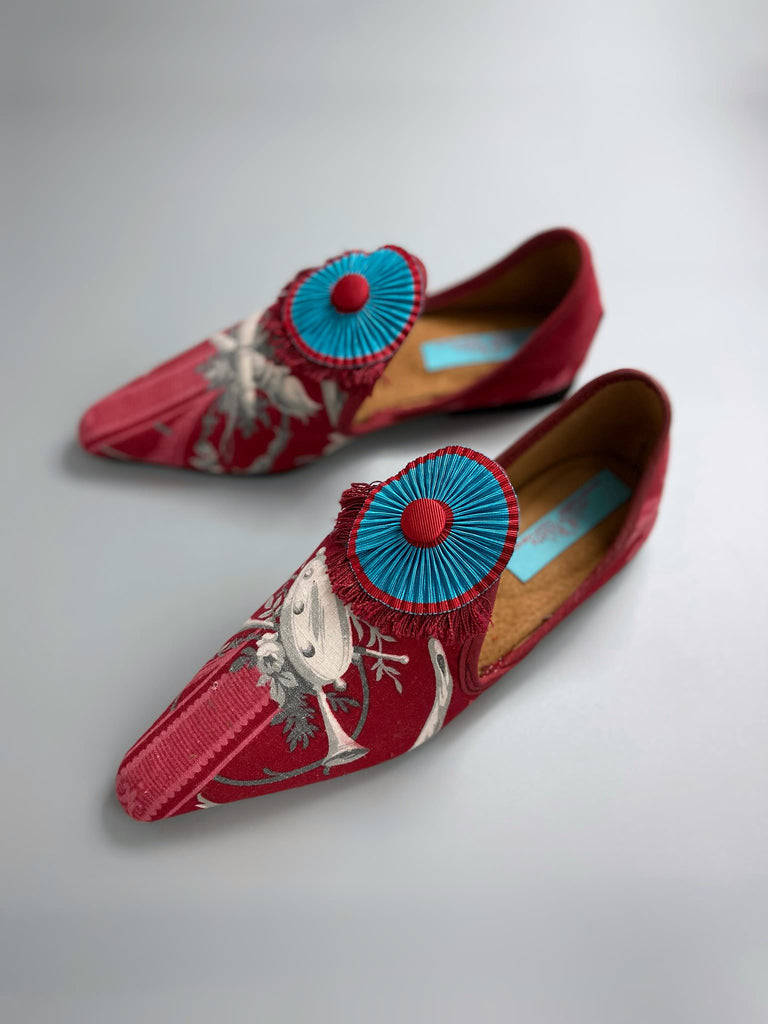 Grisaille classical motifs on crimson toile pointed toe shoes with pleated turquoise red silk ribbon embellishment. Bohemian style sustainably created from antique textiles by the Pavilion Parade studio.