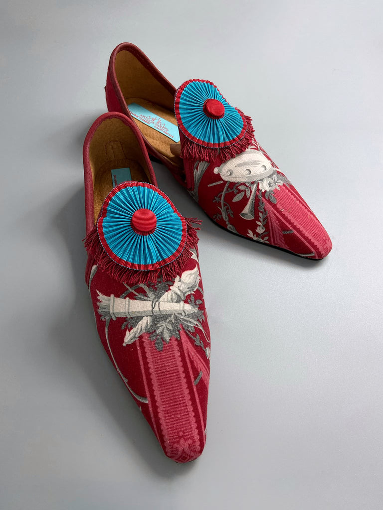 Grisaille classical motifs on crimson toile pointed toe shoes with pleated turquoise red silk ribbon embellishment. Bohemian style sustainably created from antique textiles by the Pavilion Parade studio.