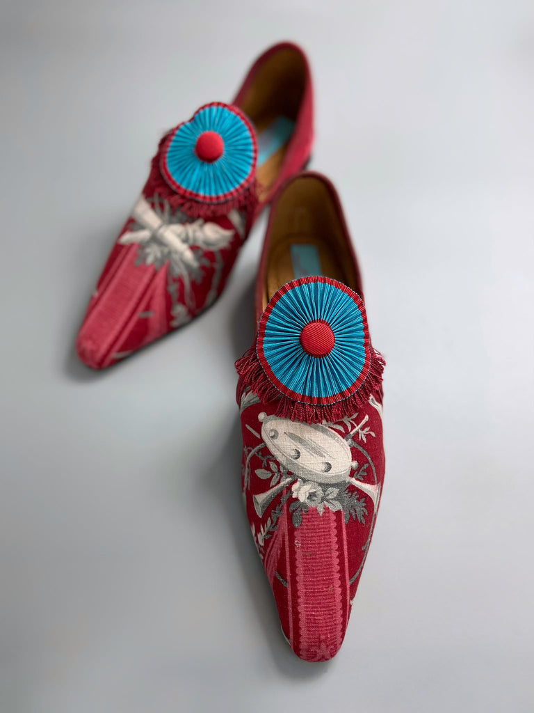 Grisaille classical motifs on crimson toile pointed toe shoes with pleated turquoise red silk ribbon embellishment. Bohemian style sustainably created from antique textiles by the Pavilion Parade studio.