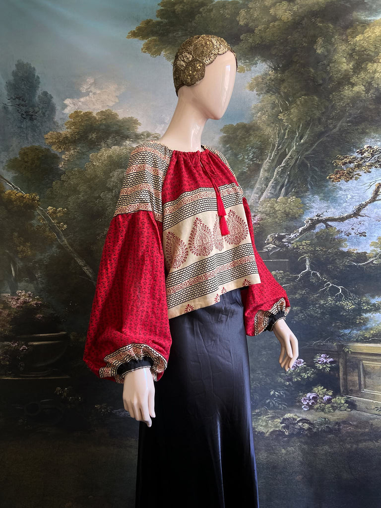 Red, stone and black cotton block printed blouse with long full sleeves and adjustable drawstring neckline. Bohemian styles sustainably created from antique and vintage textiles by the Pavilion Parade studio. 