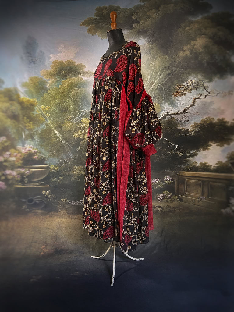 Blood red and ebony black fine cotton volume muslin dress with pockets and full balloon sleeves. Inspired by the aesthetic dress of the early 20th century. Bohemian style sustainably created from vintage and antique textiles by the Pavilion Parade studio