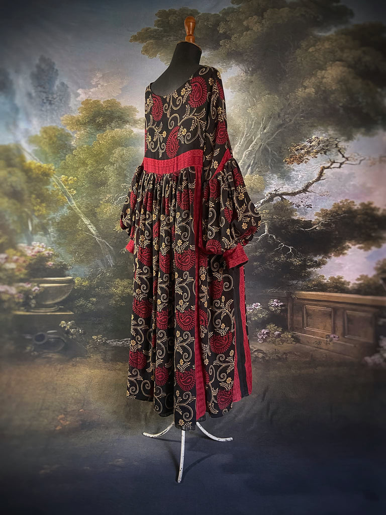 Blood red and ebony black fine cotton volume muslin dress with pockets and full balloon sleeves. Inspired by the aesthetic dress of the early 20th century. Bohemian style sustainably created from vintage and antique textiles by the Pavilion Parade studio