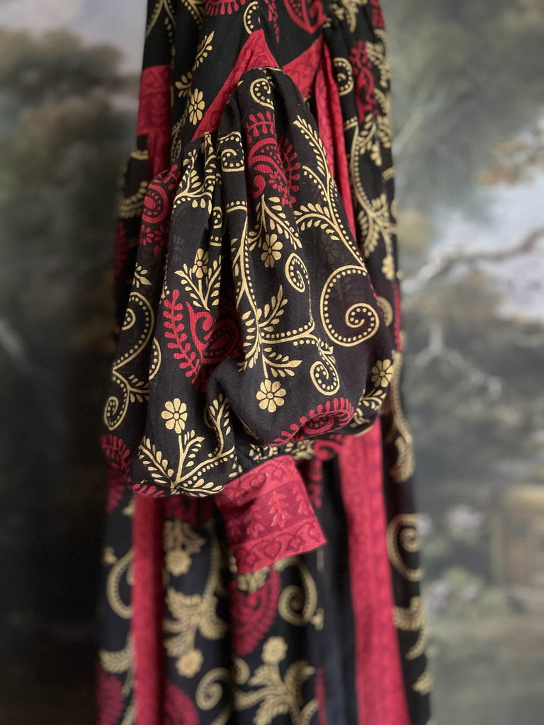 Blood red and ebony black fine cotton volume muslin dress with pockets and full balloon sleeves. Inspired by the aesthetic dress of the early 20th century. Bohemian style sustainably created from vintage and antique textiles by the Pavilion Parade studio