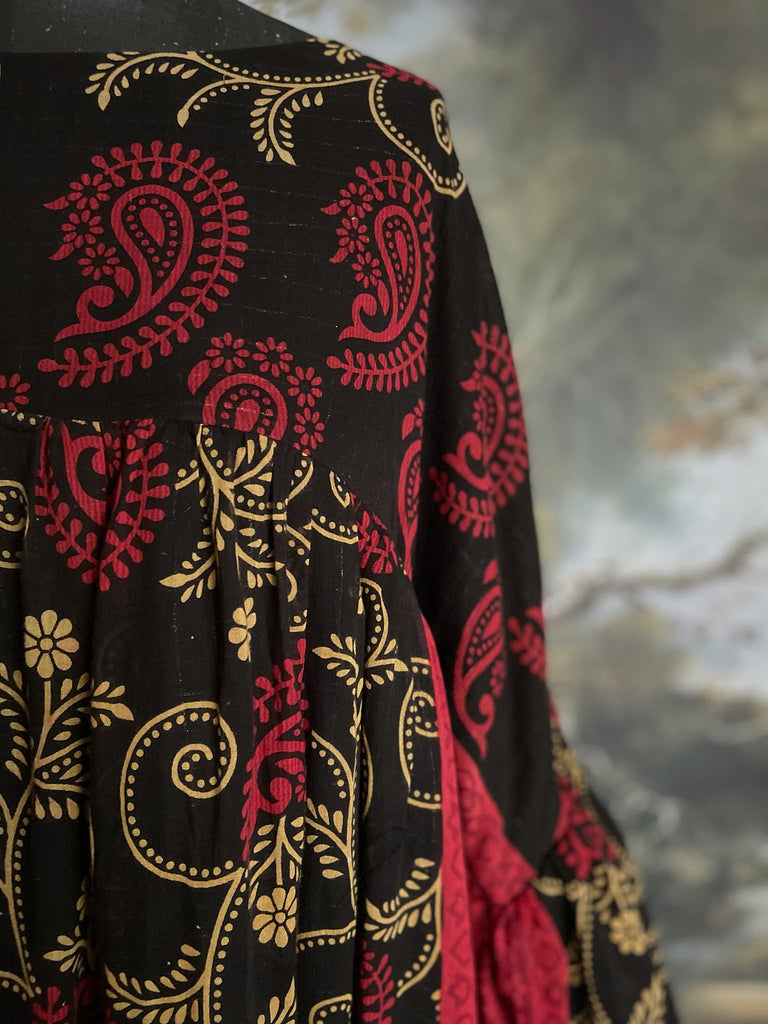 Blood red and ebony black fine cotton volume muslin dress with pockets and full balloon sleeves. Inspired by the aesthetic dress of the early 20th century. Bohemian style sustainably created from vintage and antique textiles by the Pavilion Parade studio