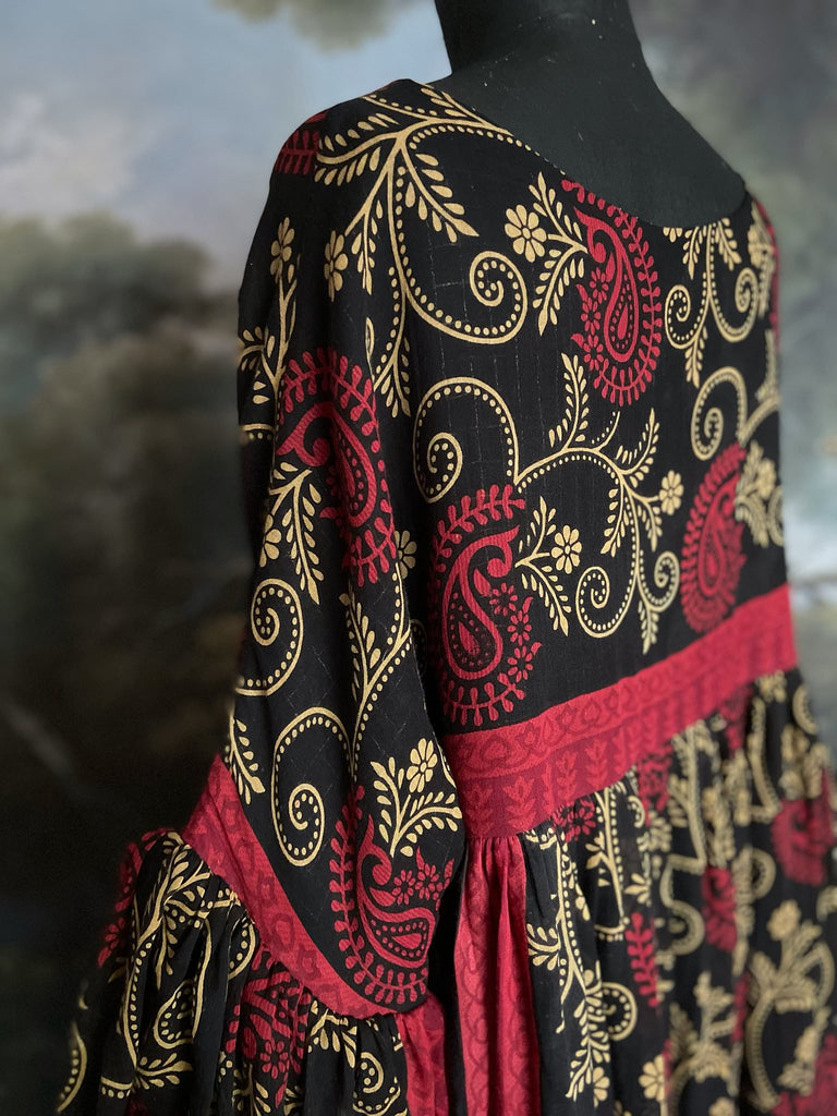 Blood red and ebony black fine cotton volume muslin dress with pockets and full balloon sleeves. Inspired by the aesthetic dress of the early 20th century. Bohemian style sustainably created from vintage and antique textiles by the Pavilion Parade studio