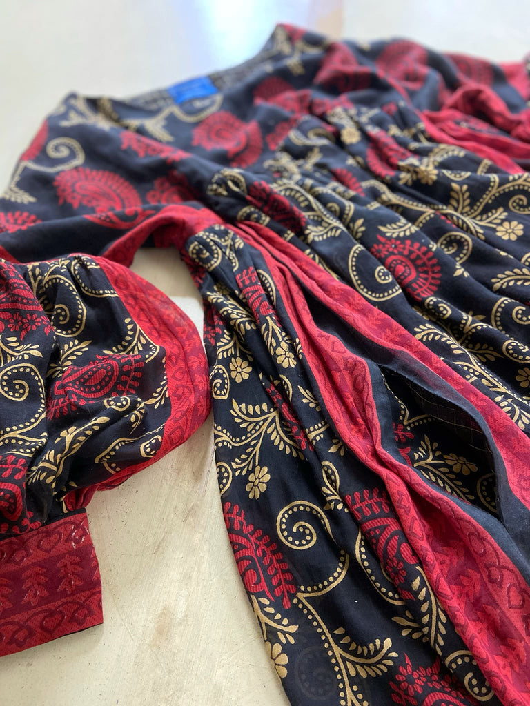 Blood red and ebony black fine cotton volume muslin dress with pockets and full balloon sleeves. Inspired by the aesthetic dress of the early 20th century. Bohemian style sustainably created from vintage and antique textiles by the Pavilion Parade studio