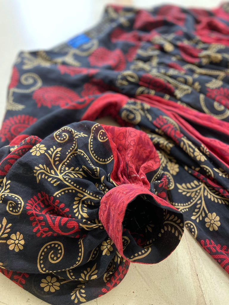 Blood red and ebony black fine cotton volume muslin dress with pockets and full balloon sleeves. Inspired by the aesthetic dress of the early 20th century. Bohemian style sustainably created from vintage and antique textiles by the Pavilion Parade studio