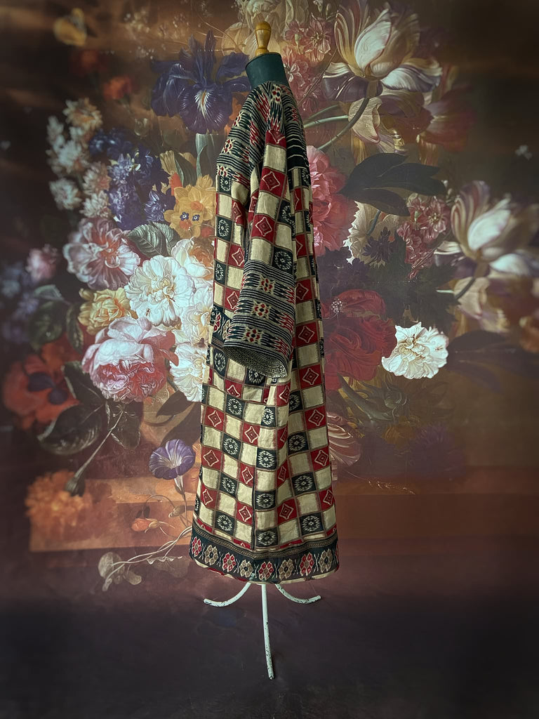 Red and black harlequin ikat print fine cotton voile kaftan dress. Fully lined, with deep pockets, wide sleeves and V neck. Bohemian styles sustainably created from antique and vintage textiles by the Pavilion Parade studio