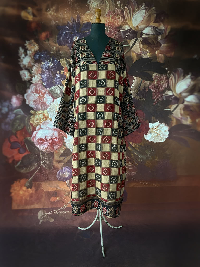Red and black harlequin ikat print fine cotton voile kaftan dress. Fully lined, with deep pockets, wide sleeves and V neck. Bohemian styles sustainably created from antique and vintage textiles by the Pavilion Parade studio