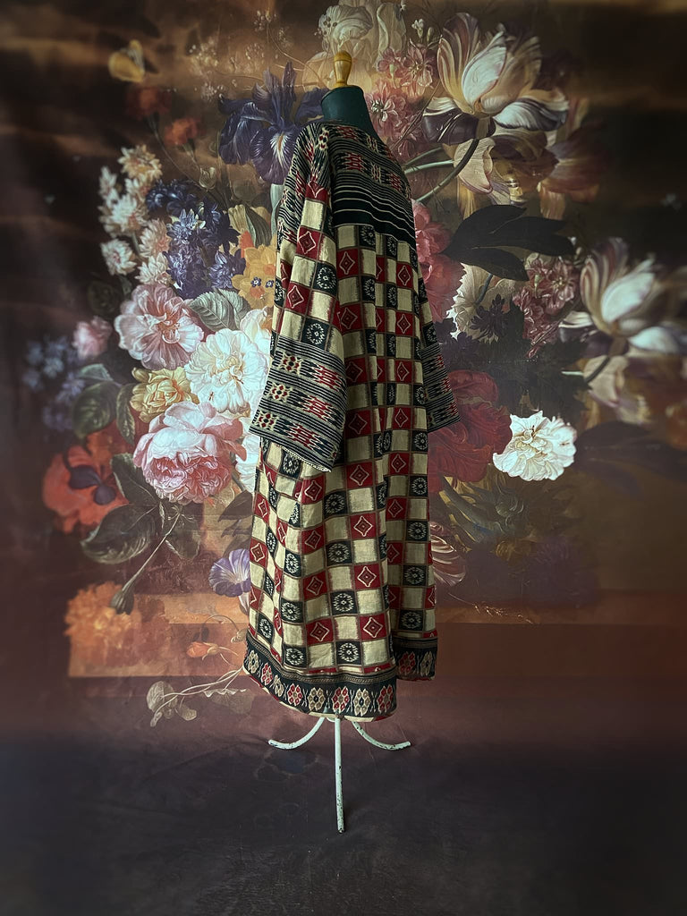 Red and black harlequin ikat print fine cotton voile kaftan dress. Fully lined, with deep pockets, wide sleeves and V neck. Bohemian styles sustainably created from antique and vintage textiles by the Pavilion Parade studio
